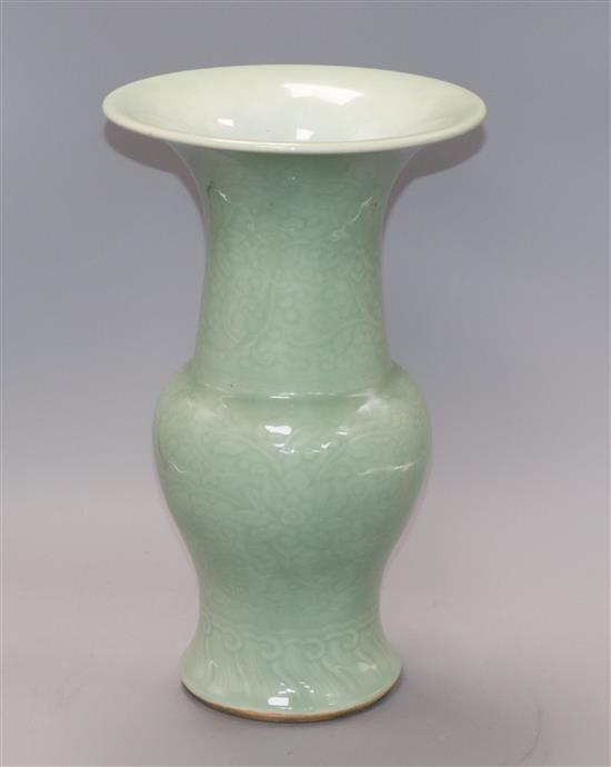 A Chinese Gu-shaped celadon vase, with floral decoration in relief and unglazed base, H 35.5cm
